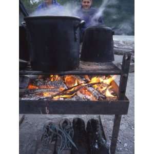  Two Men at Camp Are Drying their Shoes under Camp Cook 