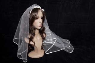 The veil edge is surrounded by white ribbon. It is mounted on a 