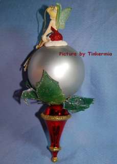 TINKERBELL IN RED SITS ATOP A 2006 SILVER BALL ORNAMENT  