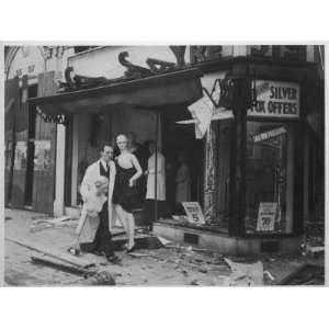 Shop Owner Poses with Two Mannequins Following the Destruction of His 