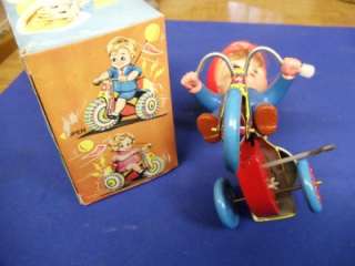  tricycle. HAPPY DAY on its flag. Toy in excellent condition. Adult 